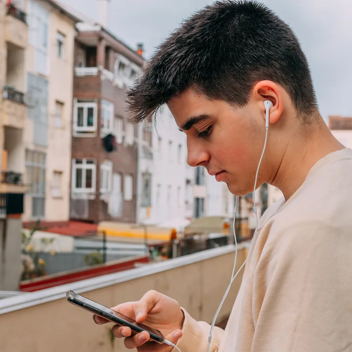 Young boy looking at mobile phone