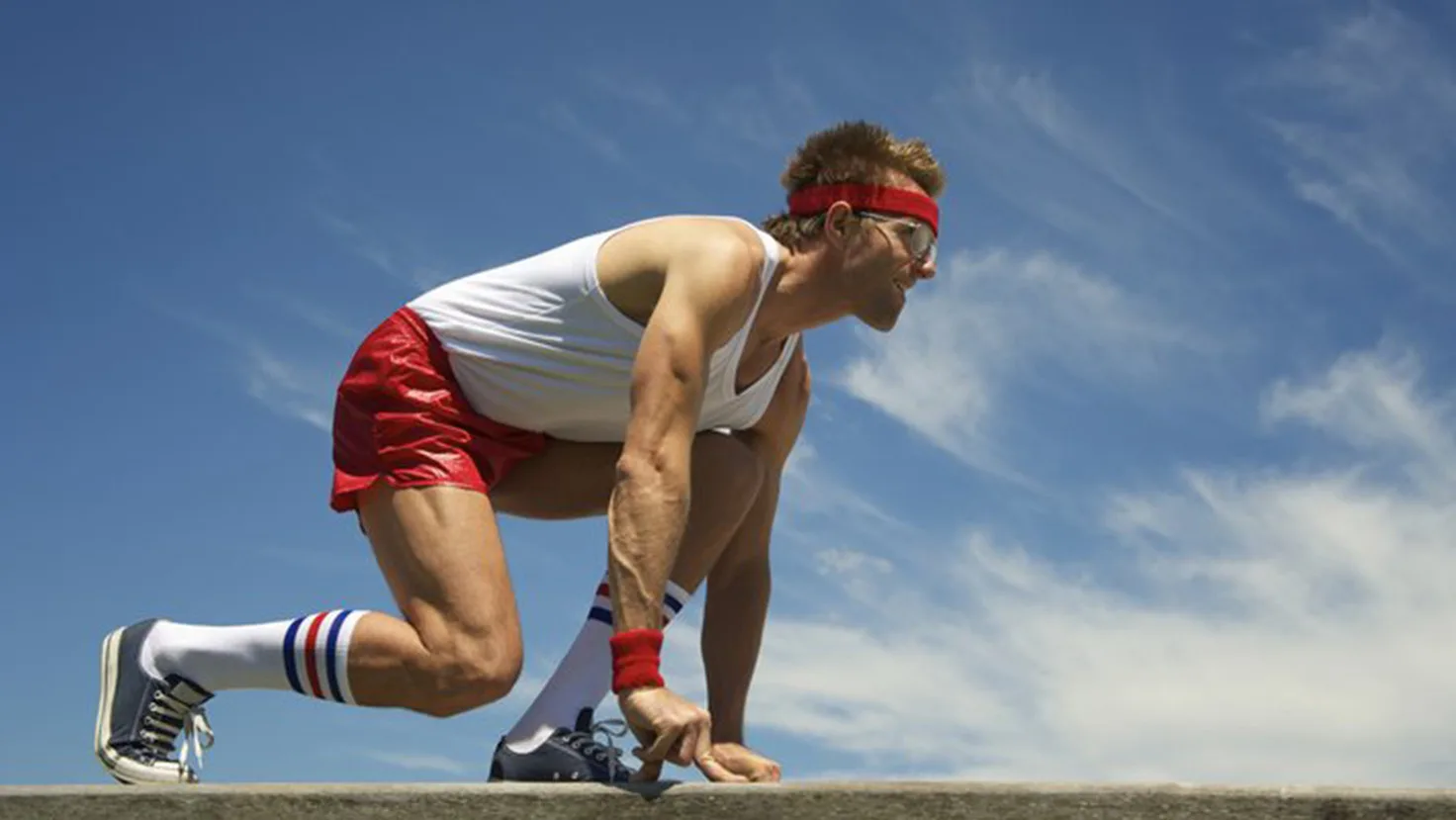 Male sprinter in starting blocks