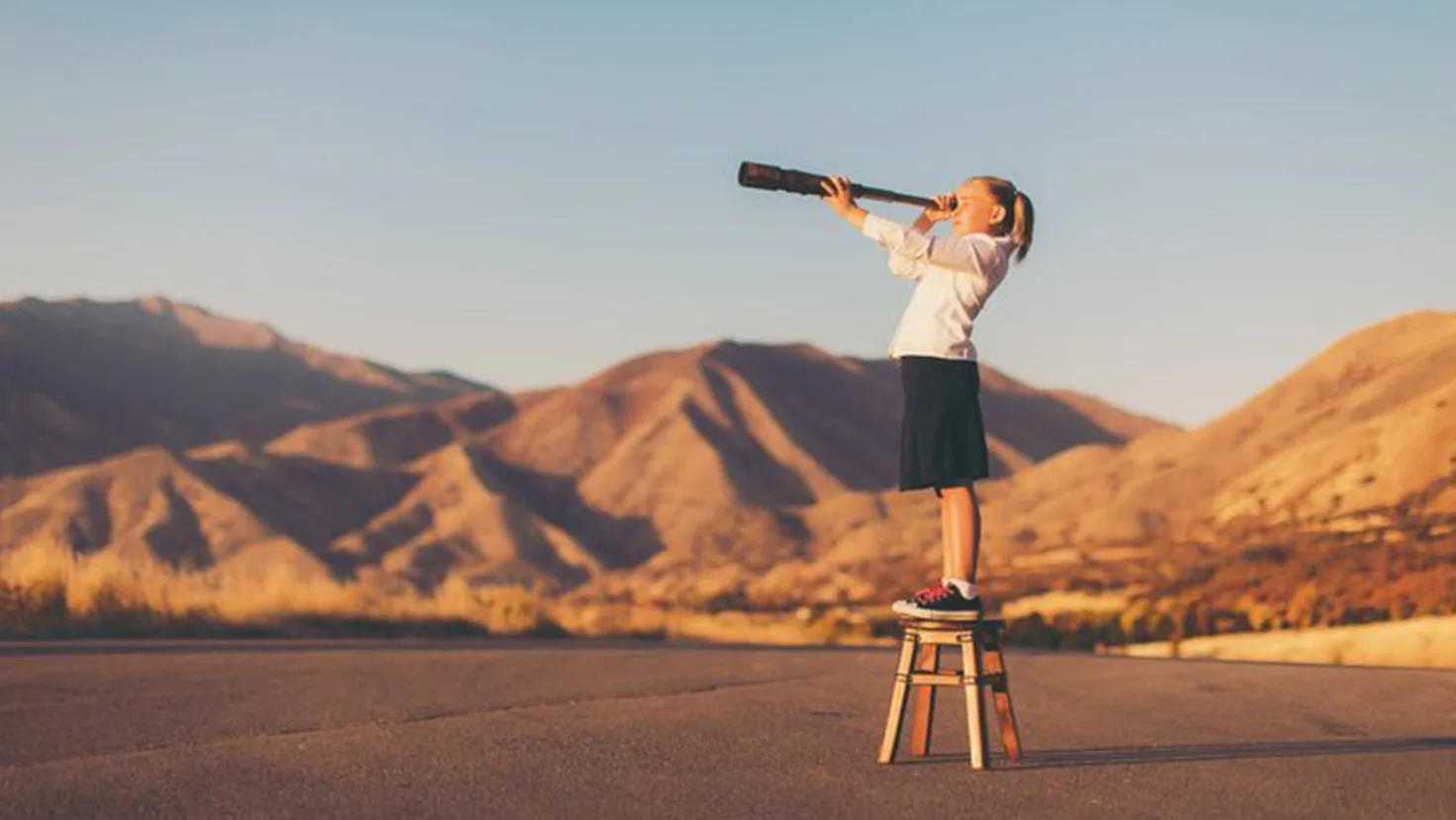 Girl in dessert with binoculars
